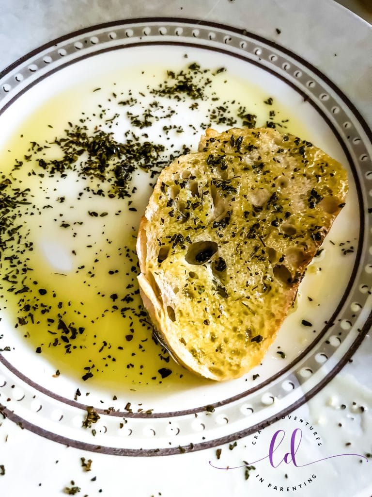 Marinade Seasoned Sourdough in Oil to Make Tomato Pesto Grilled Cheese by Dunkin'